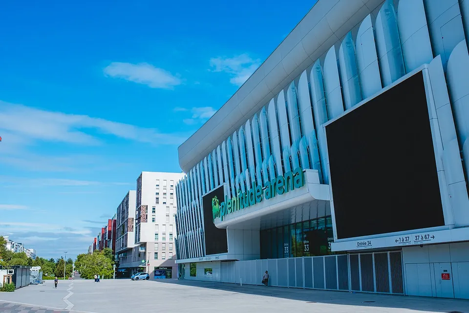 Facade of the Plenitude Arena in Nanterre with the new sign